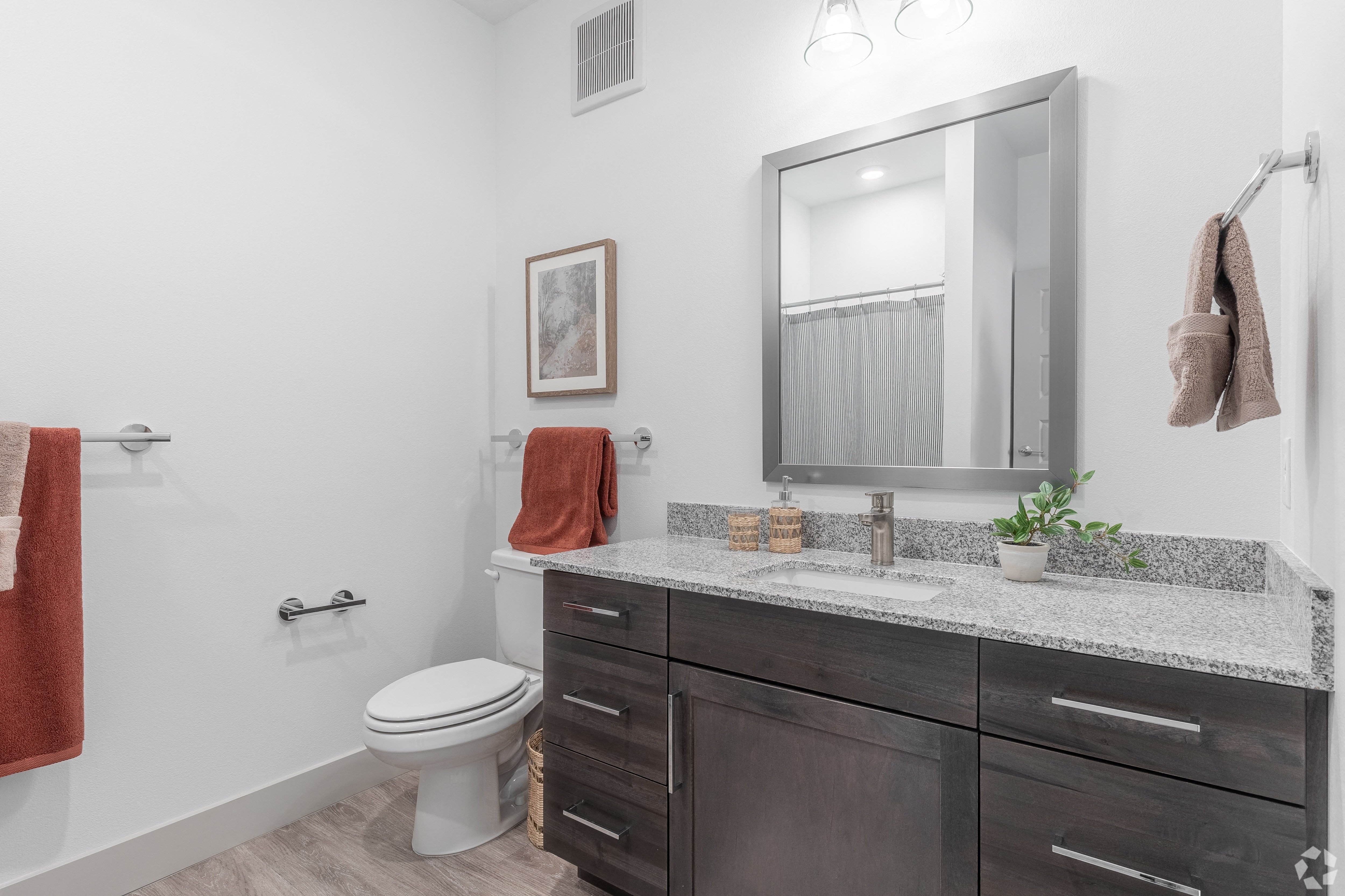 a bathroom with a toilet and a sink and a mirror